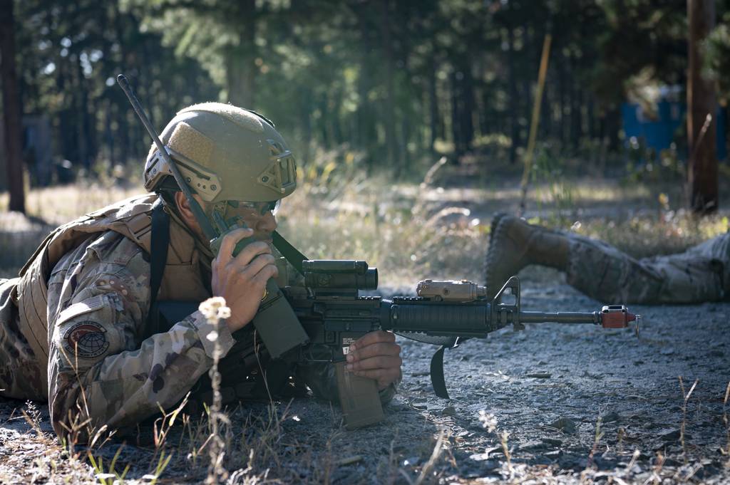 U.S. Air Force Staff Sgt. Jermaine Brown, the 621st Contingency Response Squadron noncommissioned officer in charge of readiness, responds to a simulated threat during exercise Present Ploy at Joint Base McGuire-Dix-Lakehurst, New Jersey.