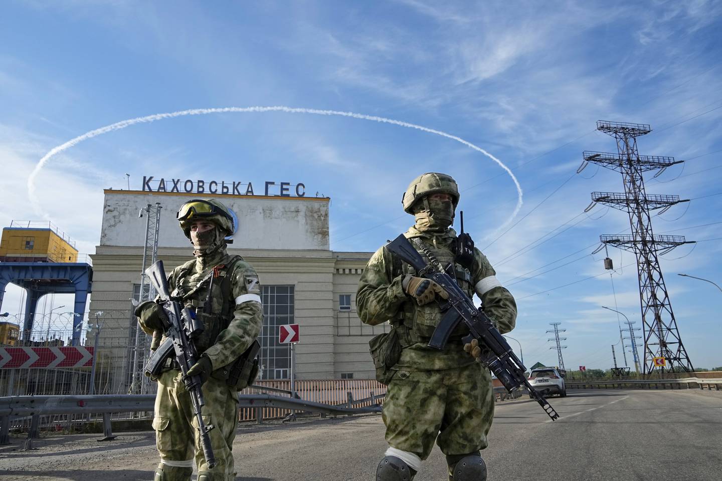 Russian troops guard an entrance of the Kakhovka Hydroelectric Station, a run-of-river power plant on the Dnieper River in the Kherson region, south Ukraine, Friday, May 20, 2022.