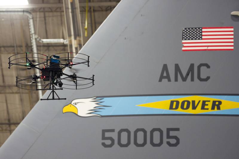 A Near Earth Autonomy drone buzzes past the tail of a Lockheed Martin C-5 cargo plane Jan. 23, 2024, in a hangar at Dover Air Force Base, Delaware.